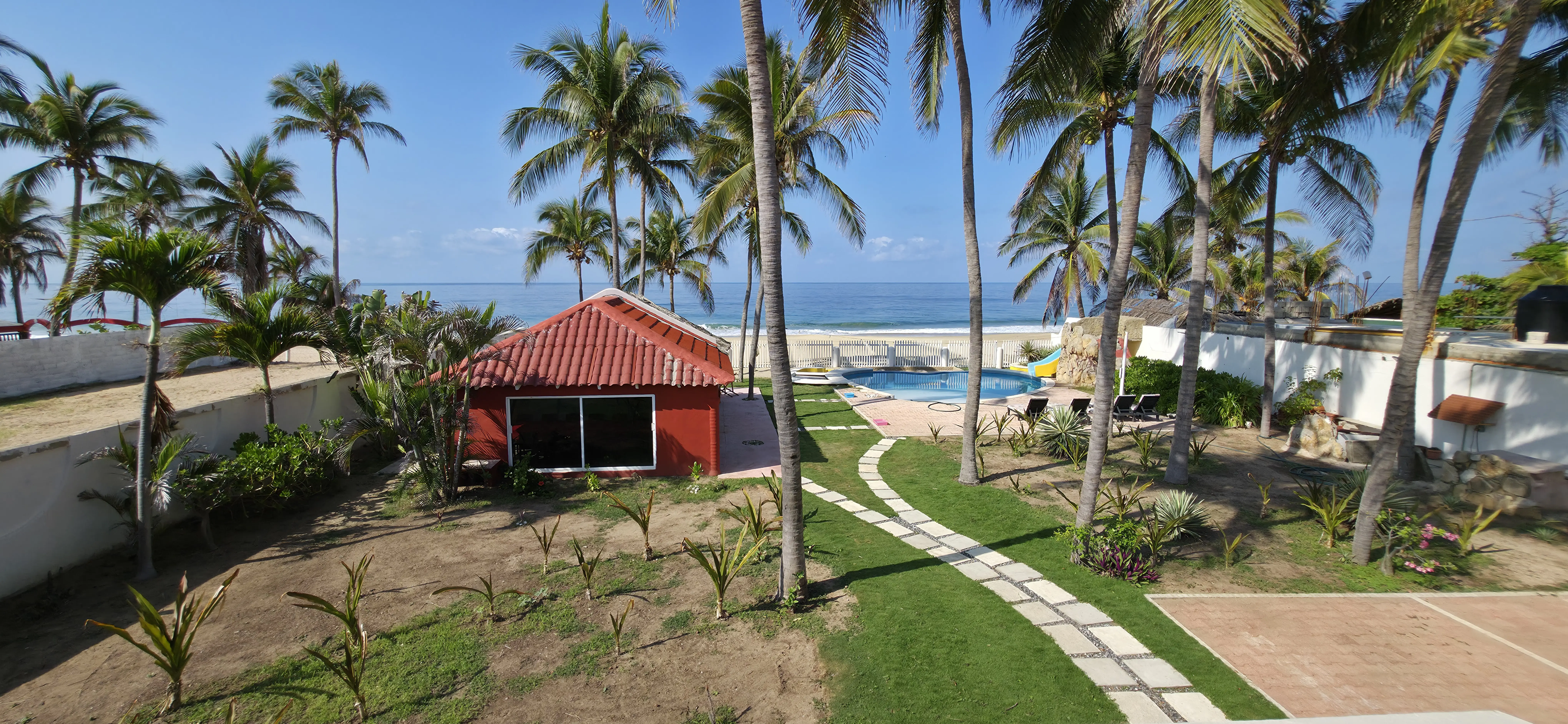 Vista panorámica de la alberca, la playa y la casa desde el balcón